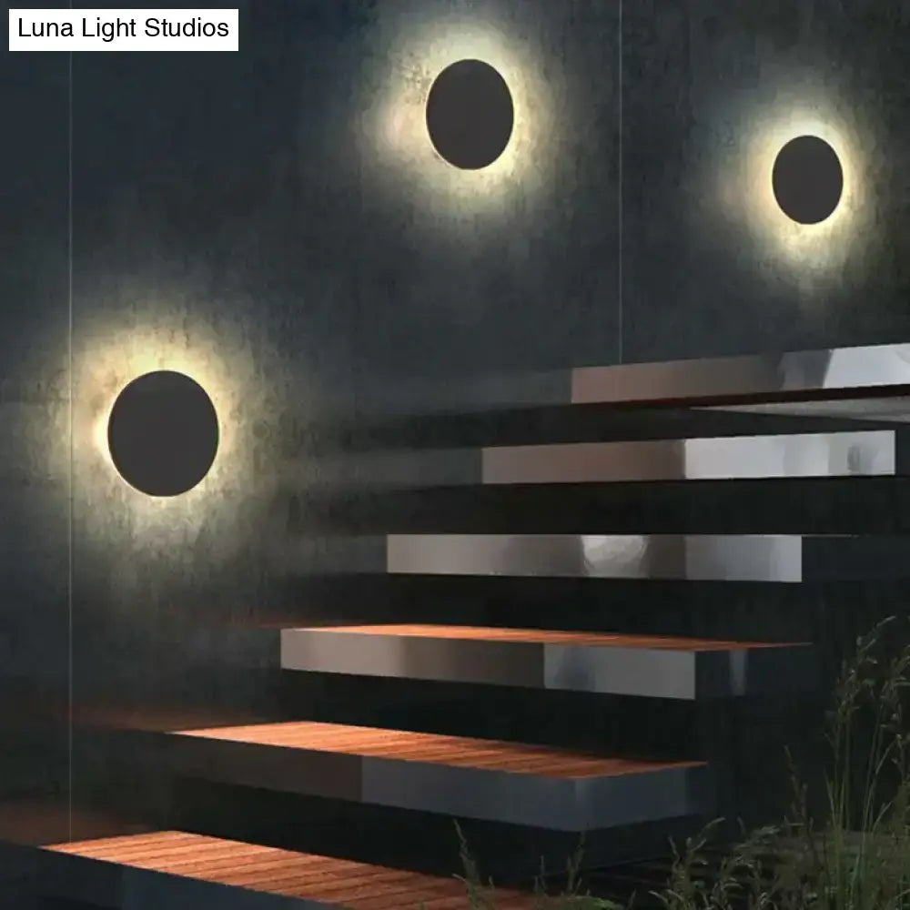 Modern black circular waterproof wall lamp set featuring sleek finish and warm glowing illumination for bedroom use