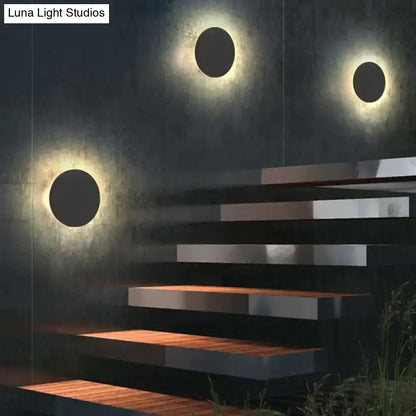 Modern black circular waterproof wall lamp set featuring sleek finish and warm glowing illumination for bedroom use
