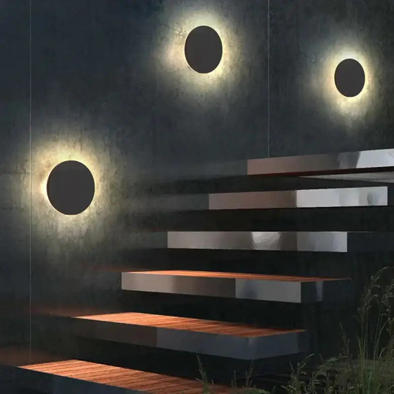 Modern black circular waterproof wall lamp bedroom set with three warm glowing disc lights on textured dark backdrop