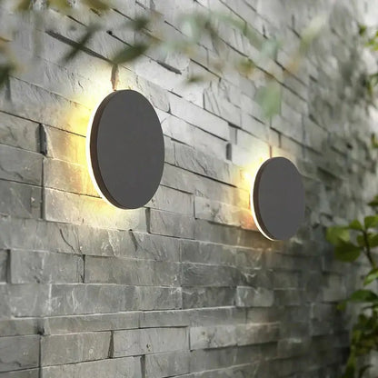 Modern black circular waterproof wall lamp set with sleek matte gray finish and warm ambient lighting for bedroom use