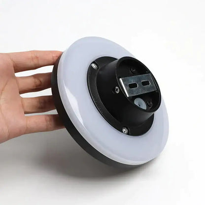 Modern black circular waterproof wall lamp with white diffuser, metal bracket, and visible screws for bedroom use