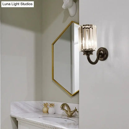 A sleek vintage-inspired wall lamp with dark bronze finish and clear crystal drum glass panels for living room use
