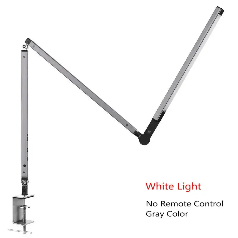 Modern black clip led desk lamp with gray adjustable metallic body and black joints emitting white light for office use