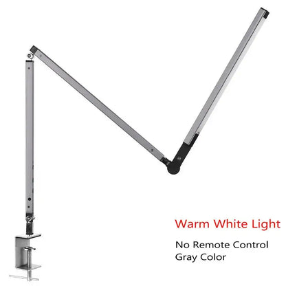 Modern black clip led desk lamp with gray metallic adjustable arm and clamp base providing warm white light ideal for office use