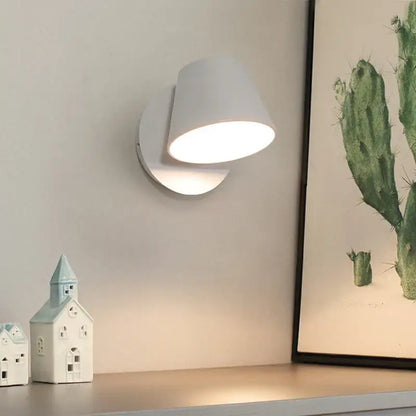 White ceramic wall lamp with sleek modern design and adjustable led lighting for bedroom reading use