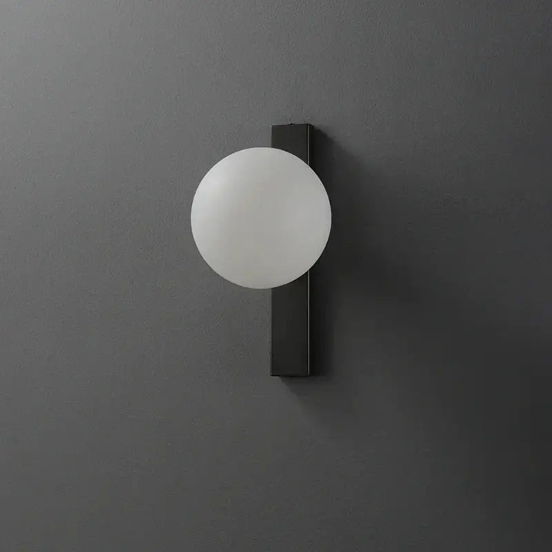 Minimalist black copper wall sconce with frosted white glass globe for modern bedroom decorbites black copper estiluz