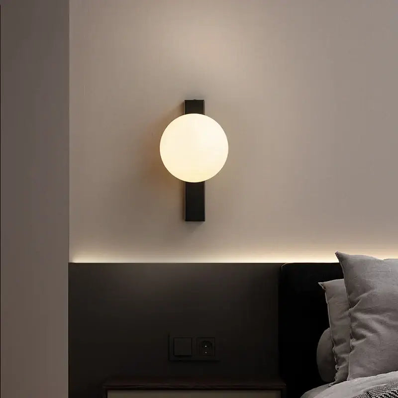 Modern black copper wall sconce with frosted glass globe for bedroom decor featuring decorbites black copper design