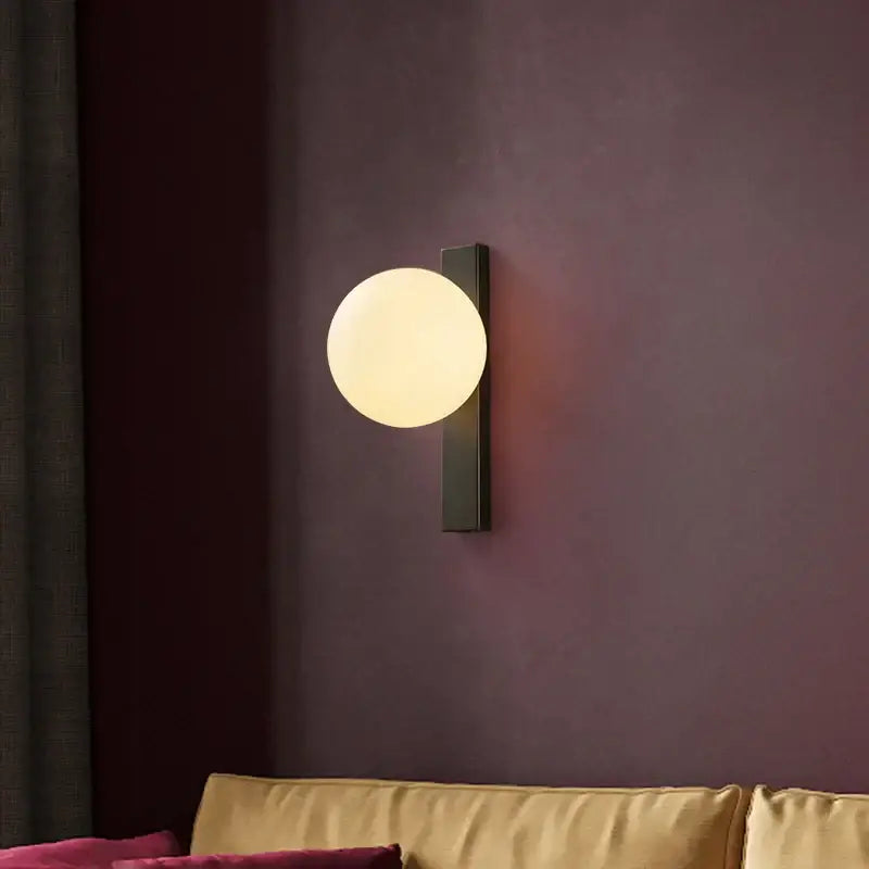 Modern black copper wall sconce with matte black base and frosted glass globe from decorbites black copper estiluz collection