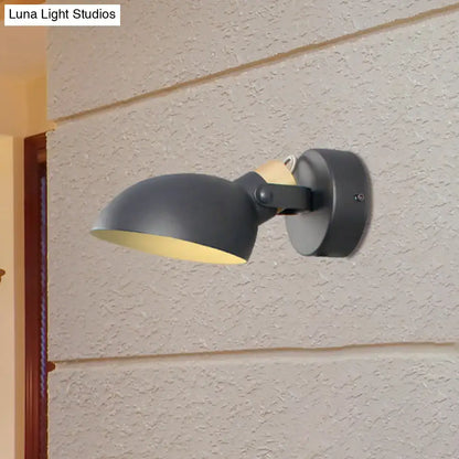 Modern black and cream wall sconce light with a matte black finish and yellow interior lining for bedroom use