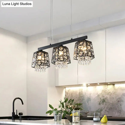 Modern black wrought iron light fixture chandelier with crystal droplet accents and ornate metalwork shade shape