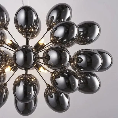 Modern black crystal grape chandelier with glossy glass globe, metallic arms, and warm light bulbs for dining room decorbites crystal grape