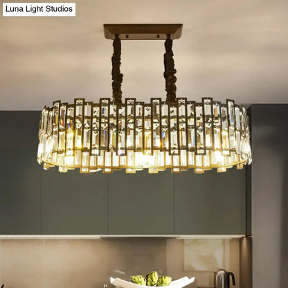 Modern black crystal island pendant light with brass frame and clear rectangular prisms for dining room illumination