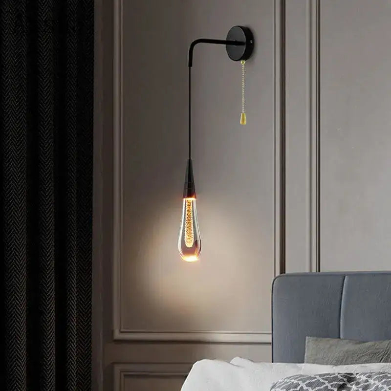 A sleek black decorbites crystal led wall lamp with a teardrop glass bulb emitting warm light for modern bedroom decor