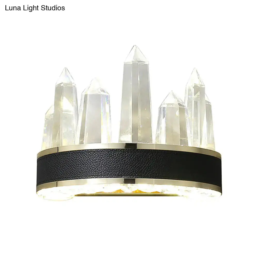 Modern black crystal led wall sconce with icicle shaped wall mount, crystal tips, textured leather band, and gold accents