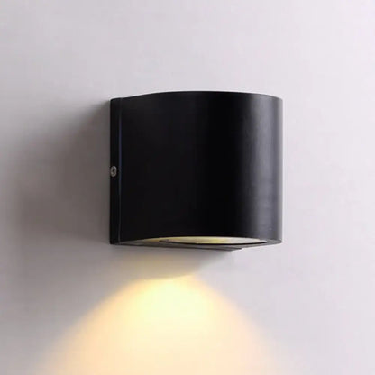 Modern black cube led wall sconce with sleek cylindrical design emitting warm yellow light for 110v-120v use