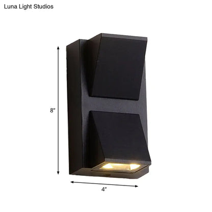 Modern black cube led wall sconce with matte finish and two angled panels emitting warm glow 110v-120v