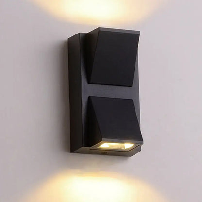 Modern black cube led wall sconce with two angled light fixtures emitting warm illumination for 110v-120v use
