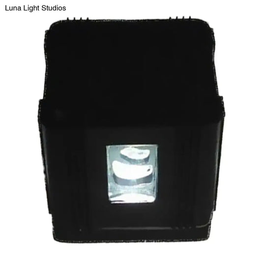 Modern black cubic led wall lamp featuring a rectangular projector with a clear lens housing three white curved light sources