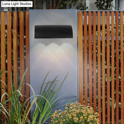 Modern black curved wall lamp outdoor minimalist led light fixture with sleek design emitting warm white light