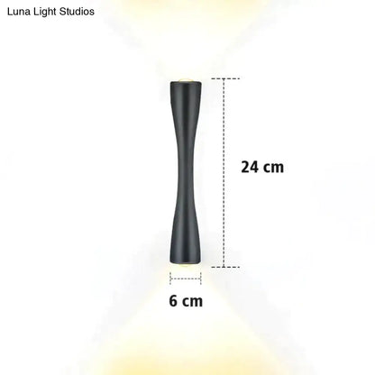Modern black curved wall sconce with black matte finish and sleek elongated design for outdoor waterproof porch lighting