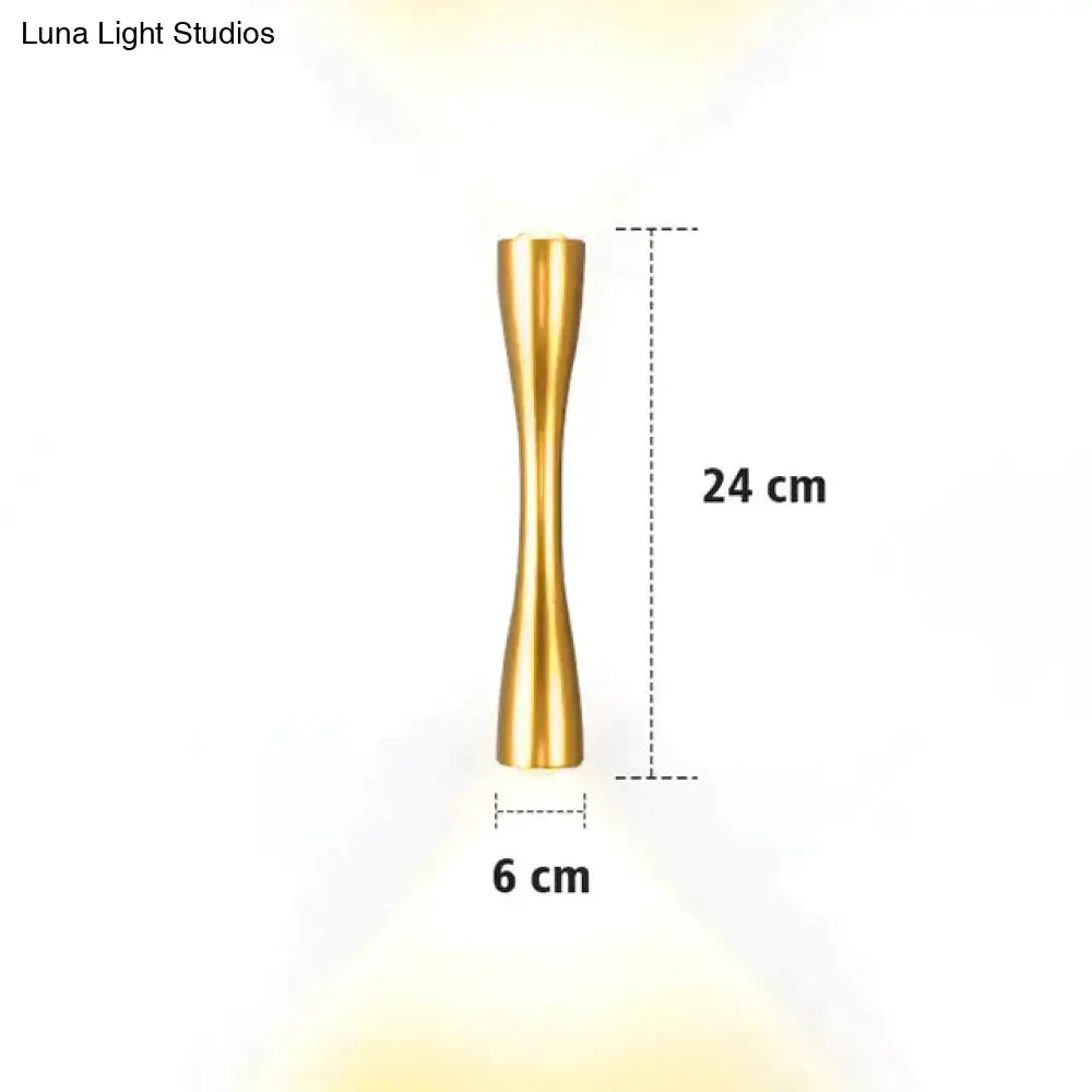 A sleek 24 cm tall gold-toned metallic floor lamp with a slender hourglass design shown with a modern black curved wall sconce outdoor waterproof porch light