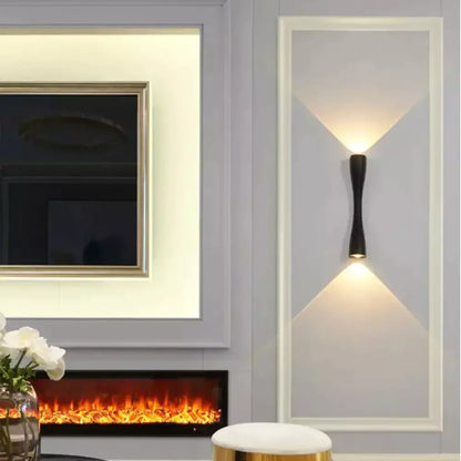 Modern black curved wall sconce outdoor waterproof porch light with sleek elongated design casting warm v-shaped light