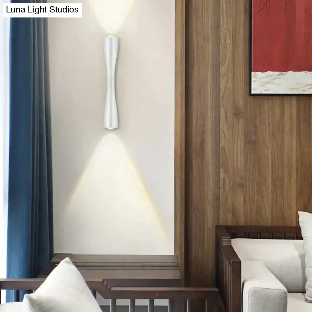 A sleek modern black curved outdoor waterproof wall sconce porch light casting warm focused light