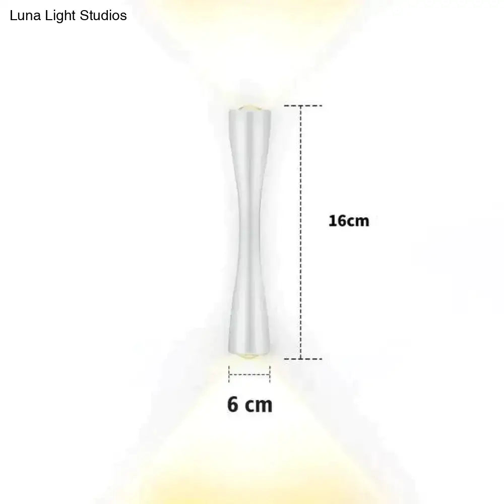 A sleek white led wall sconce with a modern hourglass shape and metallic finish for outdoor porch lighting