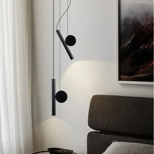 Modern black cylindrical adjustable led pendant lamps with circular accents hanging on thin wires for dining room decorbites