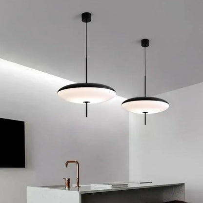Two sleek black designer iron pendant lights with frosted glass shades for dining room decorbites pendant light