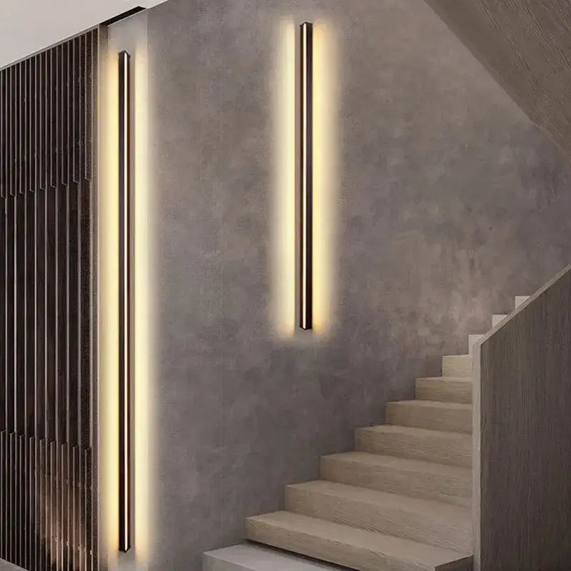 Two sleek modern black decorbites dimmable long wall lamps emit warm ambient light for bedroom lighting decor