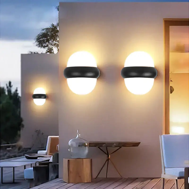 Modern black and white led wall light with frosted glass shades designed for outdoor warm lighting use