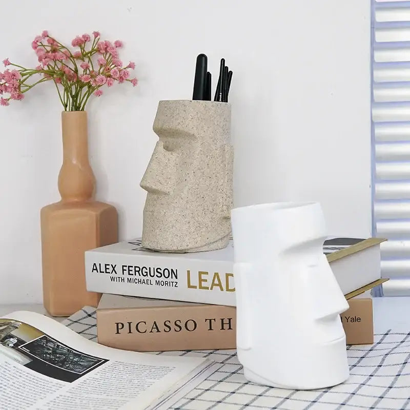 Beige stone-textured moai head resin desktop organizer pen holder with black pens by decorbites desktop organizer