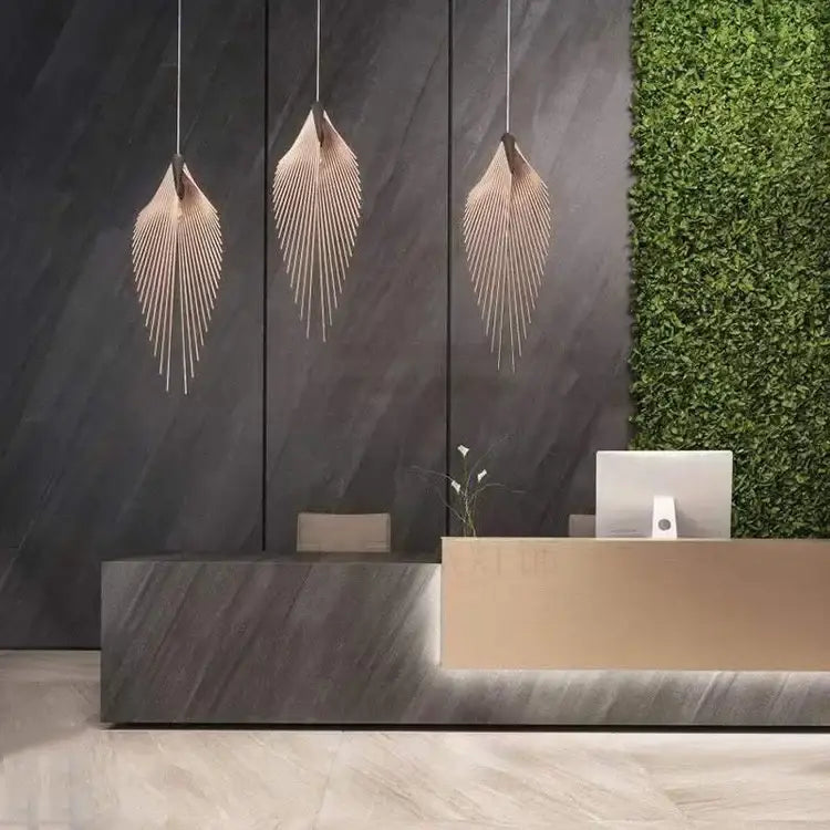Three elegant black flying wing shape pendant lights with warm brass finish for living room ceiling lighting