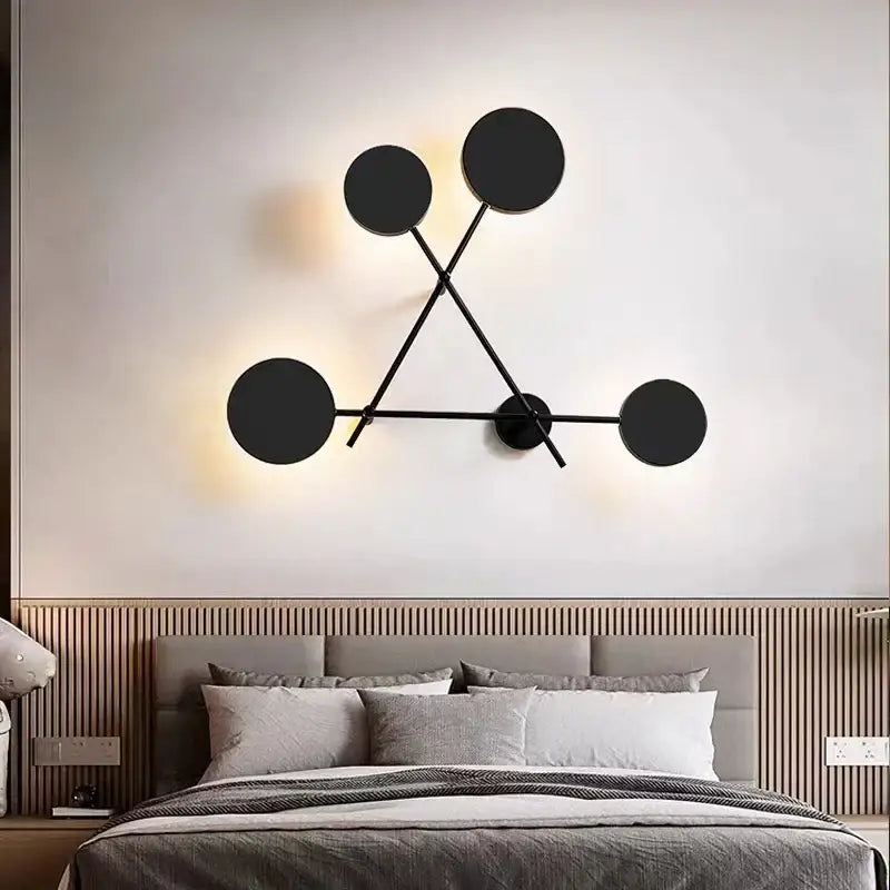 Modern black geometric led wall lamp featuring a circular design with a tripod structure for living room use