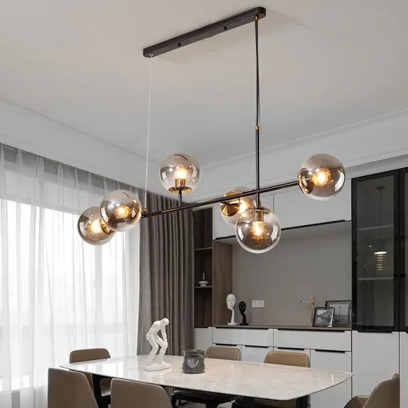 Modern black metal chandelier with five spherical glass globe lights featuring decorbites glass ball pendant lamps design