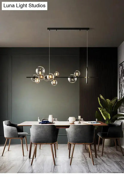 Modern black metal chandelier with clear glass globe bulbs featuring bulb base design for dining table light type