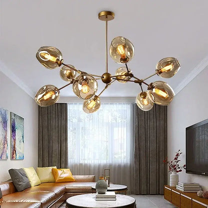 Modern black glass led chandelier pendant light featuring a gold-toned frame with amber glass globes and exposed bulbs