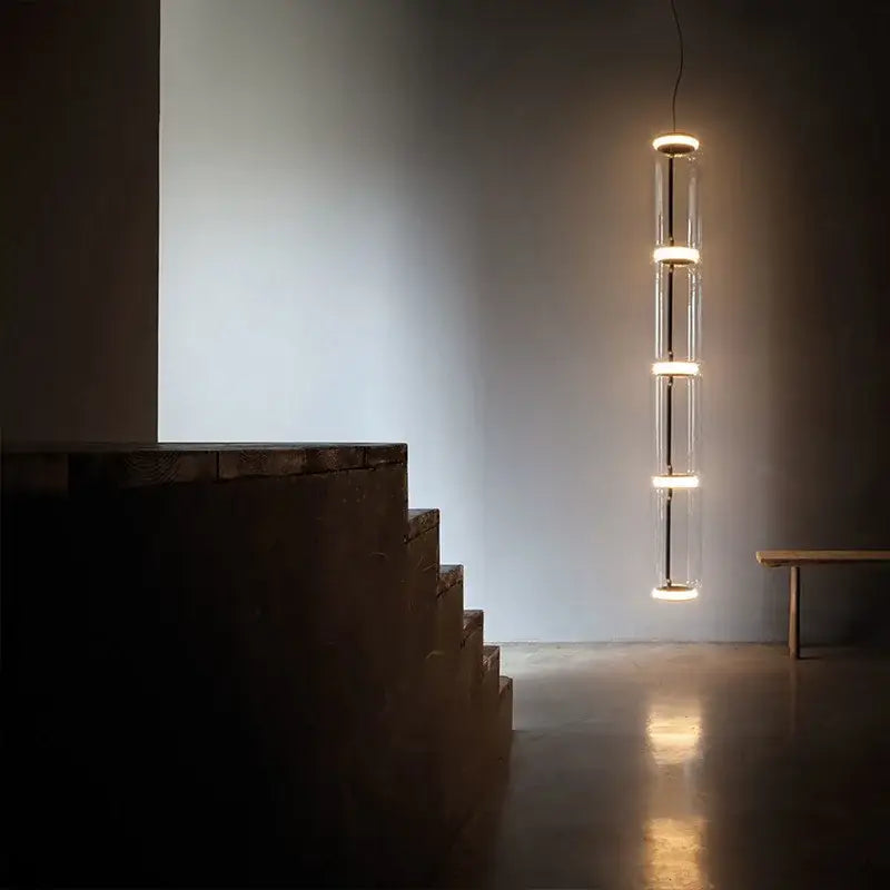 Modern black glass led pendant light with clear glass tubes and warm led rings for dining room illumination