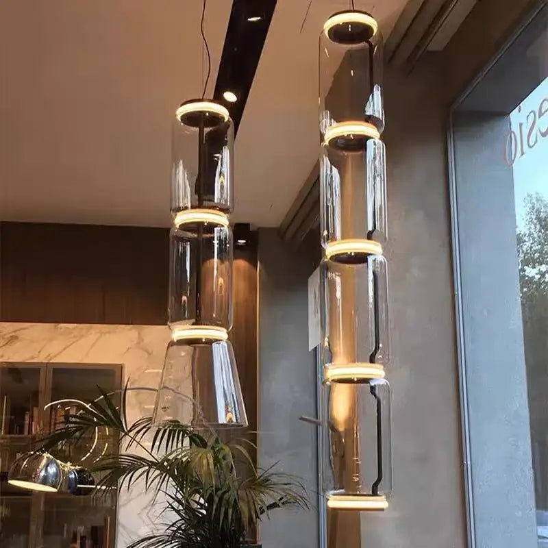 Modern black glass led pendant light with warm led rings and sleek metal accents for dining room illumination