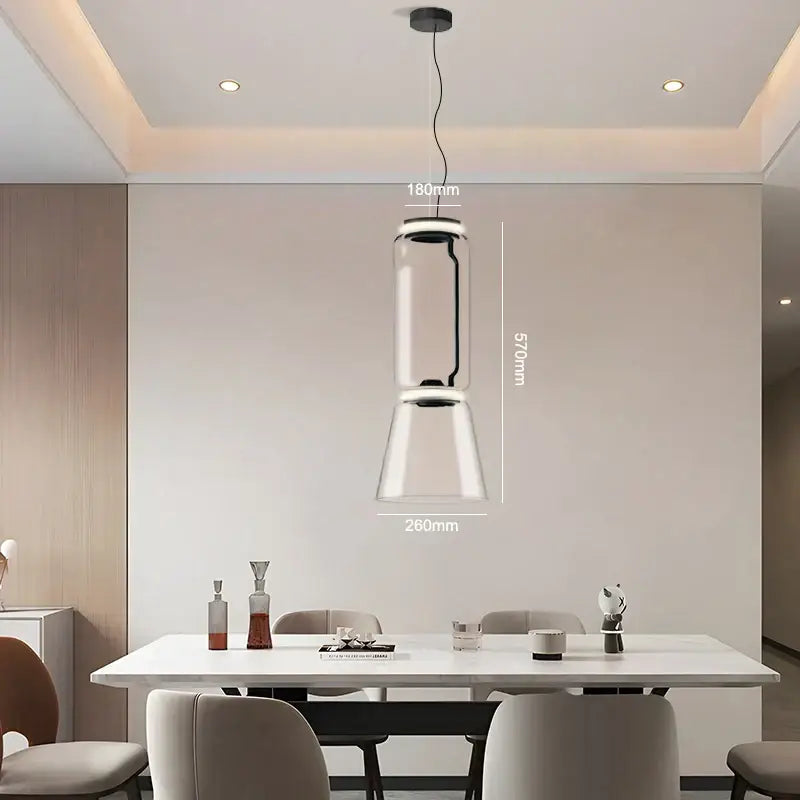 Modern black glass led pendant light with sleek cylindrical design and black metal accents for dining room use