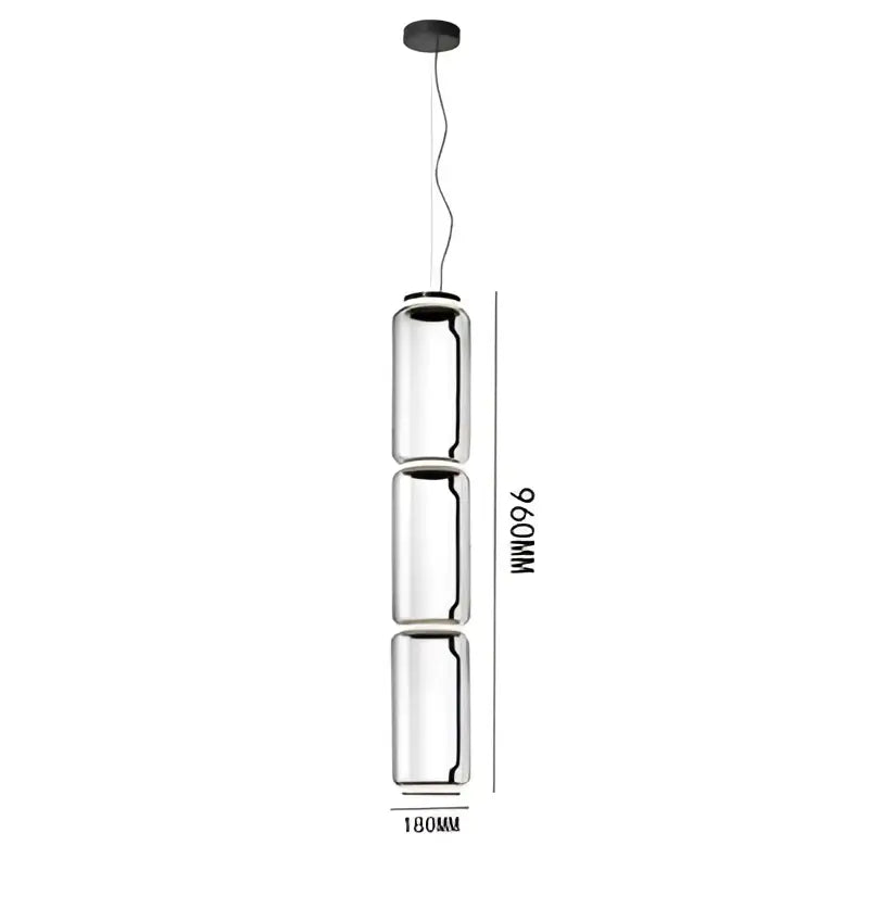 A modern black glass led pendant light with three cylindrical shades and a black ceiling mount for dining rooms