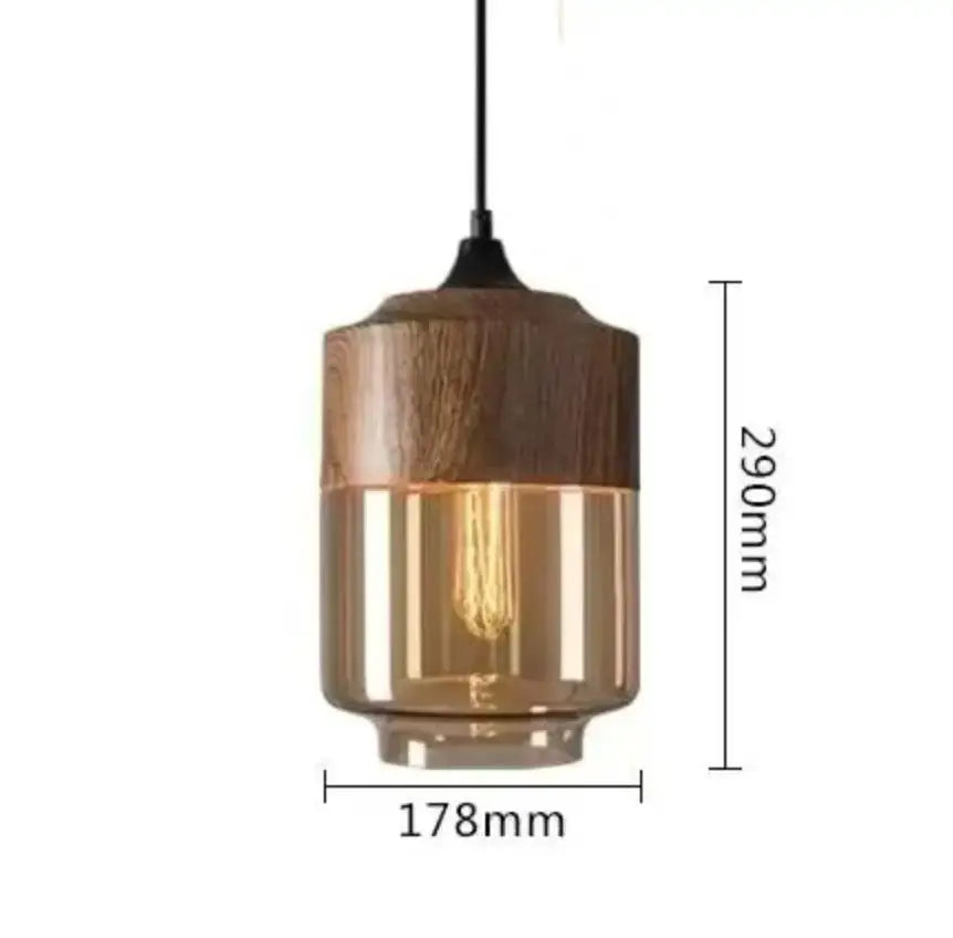 Modern black glass pendant light with warm amber glass and dark wood accents featuring exposed filament bulb for dining room decorbites black glass