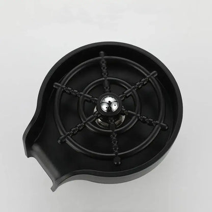 Modern black glass rinser sink featuring a black resin bar sink with ship’s wheel design and metallic center