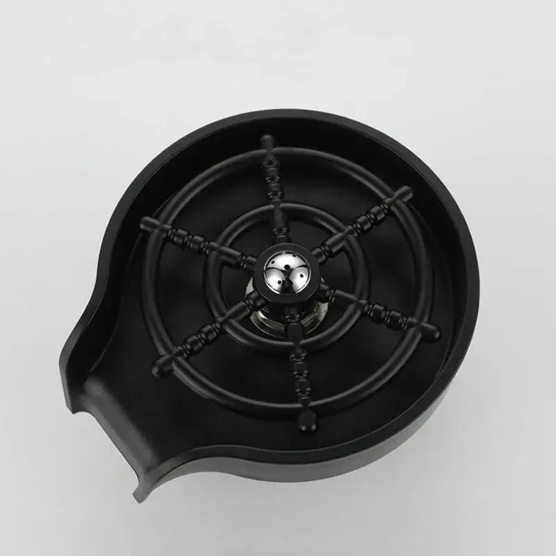 Modern black glass rinser sink featuring a black resin bar sink with ship’s wheel design and metallic center