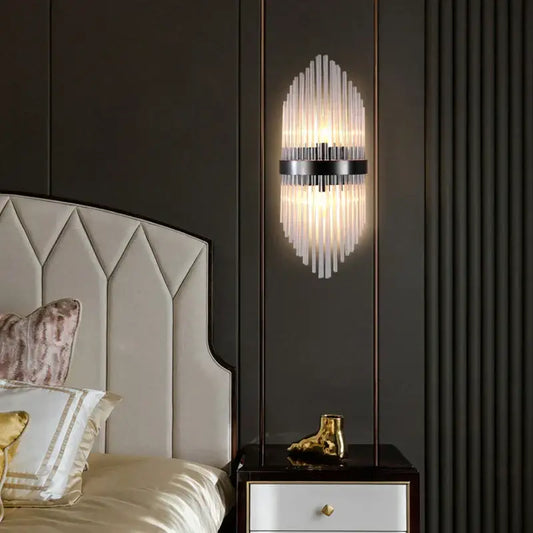 Modern black wall lamp with vertical glass rod crystal design and sleek metal frame for bedroom lighting