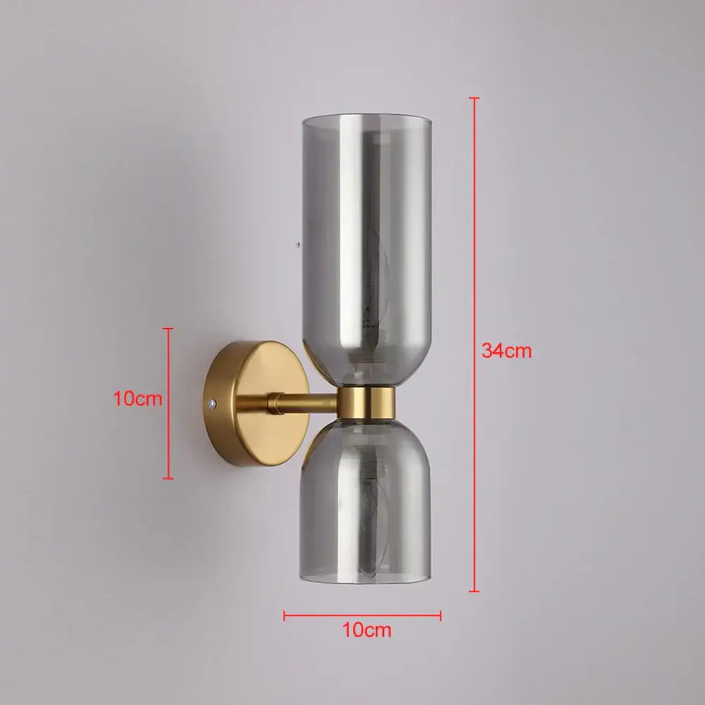 Modern brass-finished wall lamp with two smoked glass shades for bedroom featuring glass shade wall design
