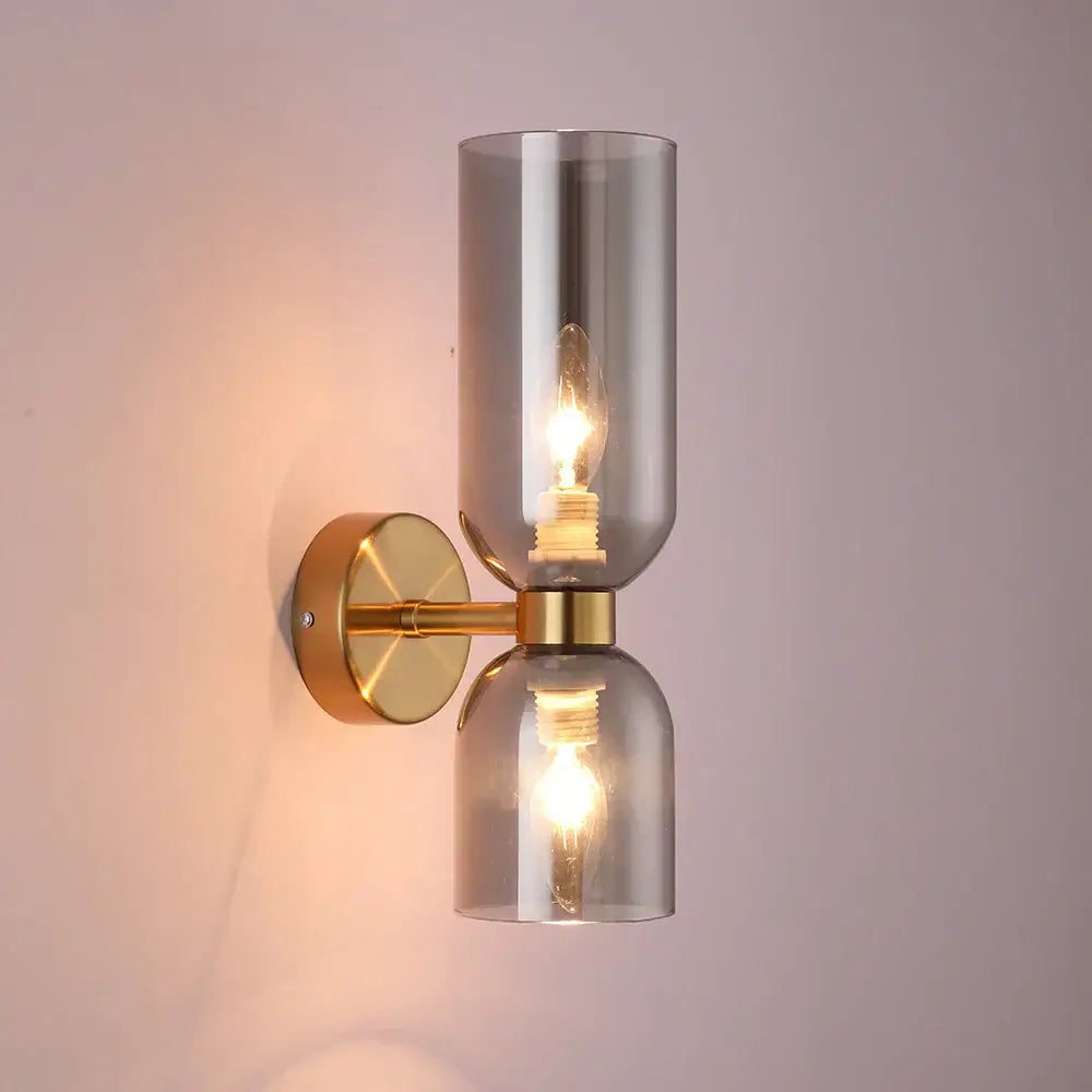 Modern wall lamp with two smoked glass shades and brass accents featuring black glass shade wall design for bedroom use