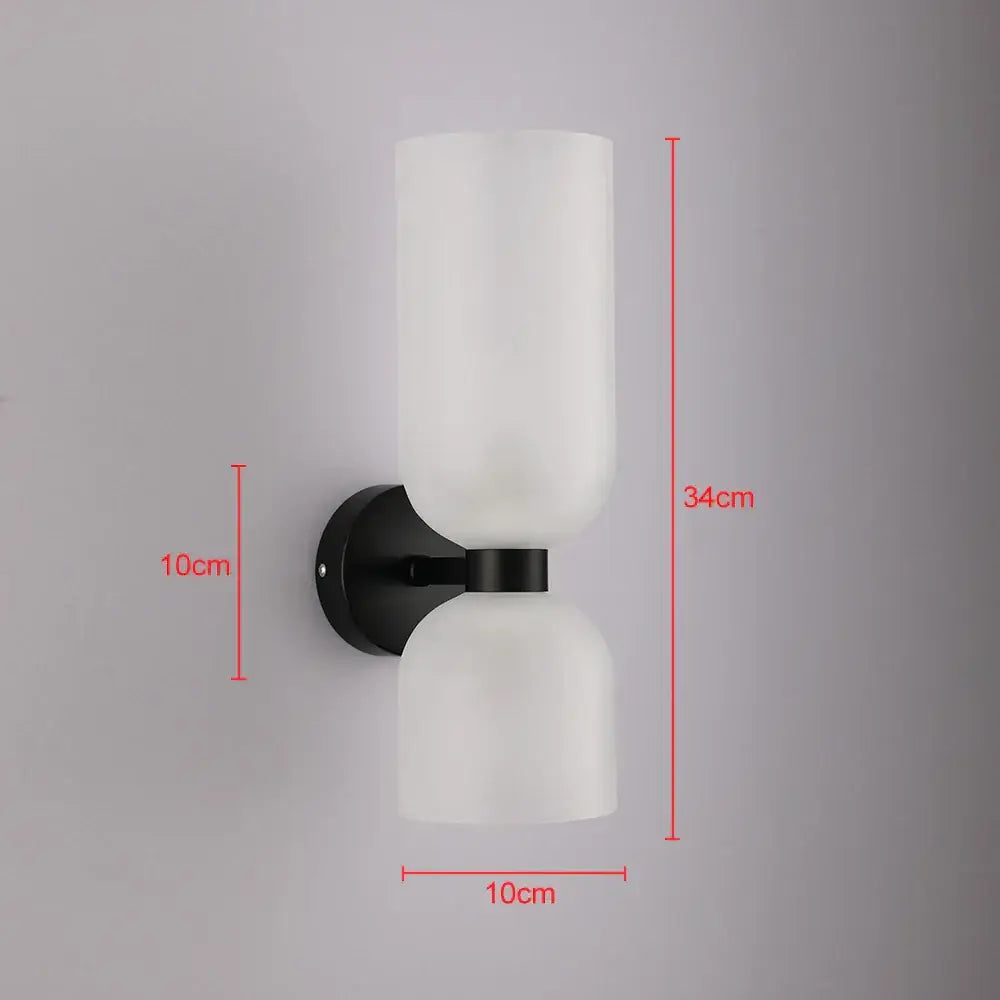 Modern black wall lamp with two frosted white glass shades featuring smoked glass for bedroom use