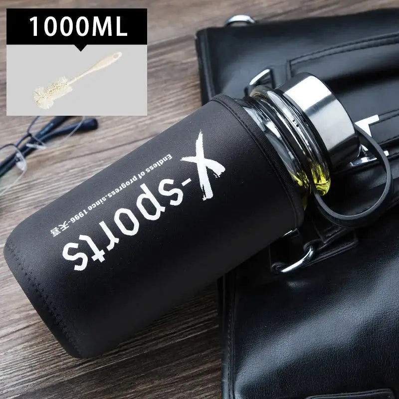 Modern black glass tea bottle with 1000ml insulated capacity and metallic lid featuring white x-sports branding by Decorbites glass tea